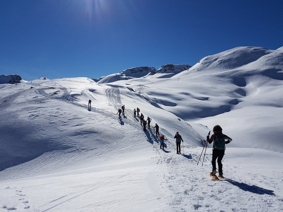 Scenic view of Santa Martino with snow-covered mountains, ideal for ski and yoga retreats in the Dolomites, Italy.